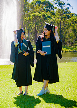 Graduates posing in front of the fountain