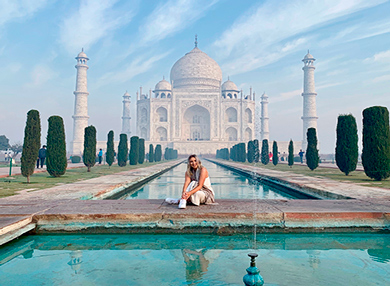 Restless Development alumnus Tara Duncan posing in front of the Taj Mahal in India