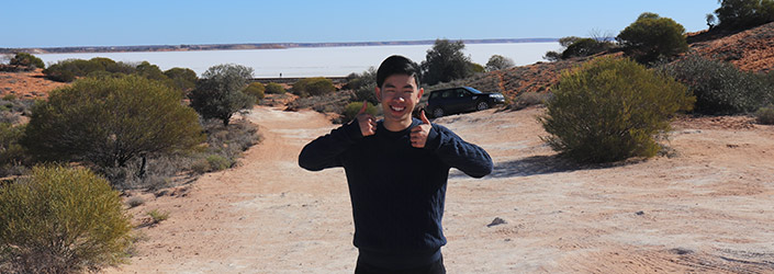 beckham standing in sand dunes