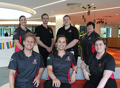 The Central Courtyard Accommodation team, seven smiling people in polo shirts.