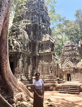 Seini standing in front of temple in Cambodia