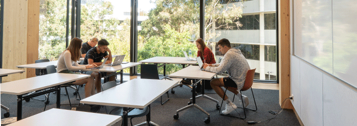 Students studying indoors at tables