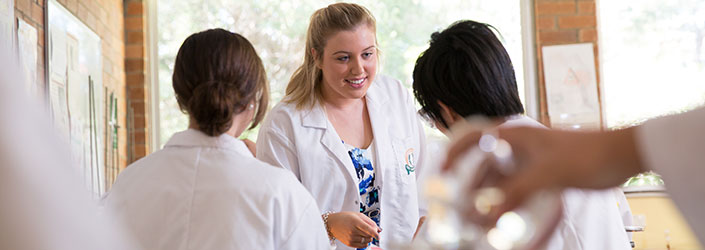 Teacher with two students in the classroom