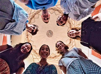 Pravah alumni inside an Indian building posing for a picture taking from the floor