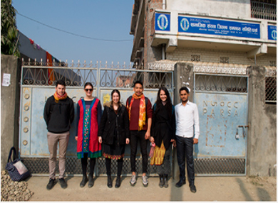 Six Restless Development Nepal alumni posing for a photograph in the streets of Nepal
