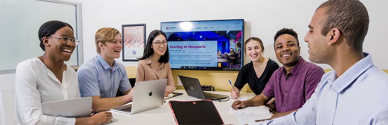 Students having a discussion at a library presentation pod