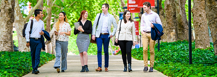 Six students in business attire walking down Wally's Walk