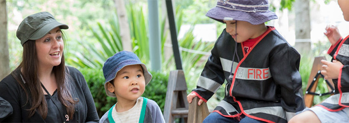 Childcare staff minding children at playground