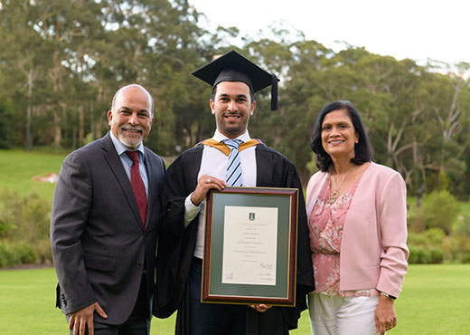 Graduate with parents holding frame
